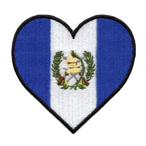 May include: A heart-shaped patch with the flag of Guatemala. The flag is blue, white, and features the national coat of arms in the center.