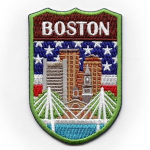 May include: Embroidered patch with a green border, featuring a cityscape of Boston, Massachusetts, with the word "BOSTON" in brown lettering at the top. The cityscape includes buildings, a bridge, and a river. The background is a blue and white American flag.