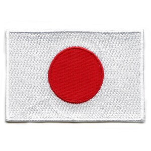 May include: A white embroidered patch with a large red circle in the center, representing the flag of Japan.