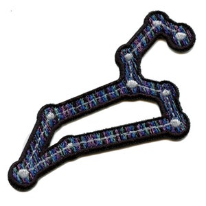 May include: An embroidered patch depicting the constellation Leo, with a black outline and a colorful plaid pattern in shades of blue, purple, and green. The stars are represented by white circles.