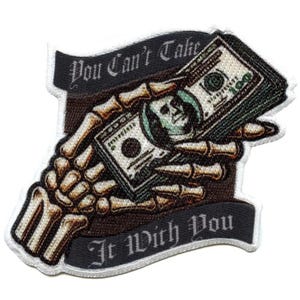May include: A black and white skeleton hand holding a stack of US dollar bills. The bills are green and have a picture of Benjamin Franklin on them. The image has the text "You Can't Take It With You" on a banner.