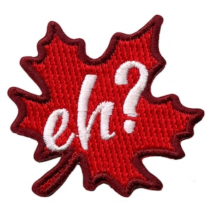 May include: Red maple leaf patch with white embroidered text that says "eh?"