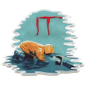 May include: An embroidered patch with a blue background and white border. The patch features a red "IT" logo and a yellow hand reaching out of the water.