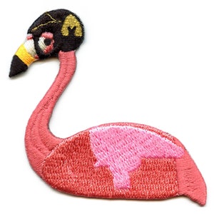 May include: Pink flamingo embroidered iron-on patch. The flamingo has a black head with a gold detail and a pink body.