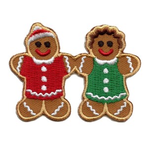 May include: Two embroidered gingerbread man patches. One wears a red shirt and Santa hat, the other a green dress. Both have brown bodies, white icing trim, and smiling faces. Perfect for holiday crafts.