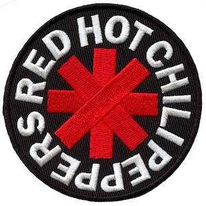 May include: Red Hot Chili Peppers logo patch with a red asterisk on a black background. The band's name is written in white around the asterisk.