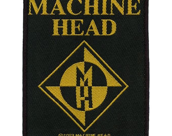 Könnte beinhalten: Schwarzer und goldener gestickter Patch mit dem Text "MACHINE HEAD" und einem rautenförmigen Logo mit den Buchstaben "MH" darin.