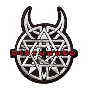May include: Black and white embroidered patch featuring a stylised logo of the band Disturbed. The logo depicts a circle with a series of interlocking triangles and two horns at the top.