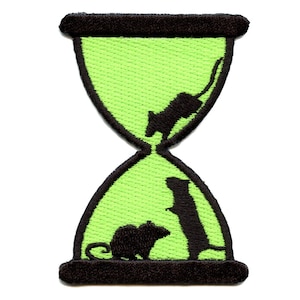 May include: An embroidered patch featuring a green hourglass with black outlines. Two black silhouettes of mice are inside the hourglass, one at the top and one at the bottom.