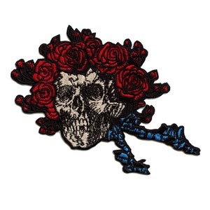 May include: Embroidered patch featuring a skull with a red rose wreath and blue ribbon detail.