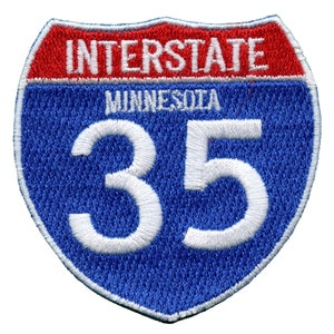 May include: A blue and red Interstate highway sign with the number 35 in white, and the text "INTERSTATE" and "MINNESOTA" in white.