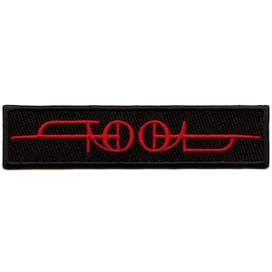 May include: Red embroidered "TOOL" logo patch on a black background.