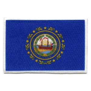 May include: A blue embroidered patch with a white border featuring the state seal of New Hampshire. The seal depicts a ship sailing on a body of water with a green wreath and gold stars surrounding it.