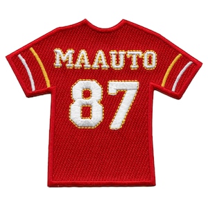May include: Red and white embroidered football jersey patch with the name "MAAUTO" and the number "87" on the back.