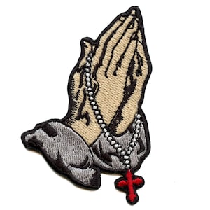 May include: Embroidered iron-on patch of praying hands with a silver chain and a red cross pendant.