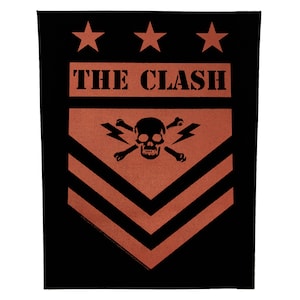 May include: Black and orange patch with the text "THE CLASH" above a skull, crossbones, and lightning bolts design. Three stars are at the top. The patch has a black border.