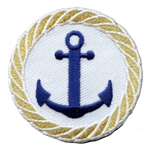 May include: A blue anchor embroidered on a white circle with a gold rope border.