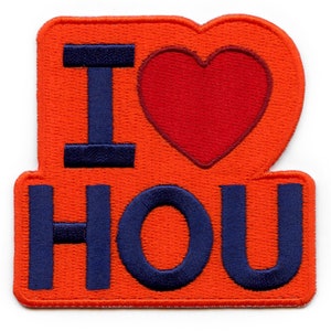 May include: An orange felt patch with the words "I love HOU" in blue embroidered lettering. A red heart is between the words "I" and "love".