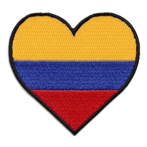 May include: A heart-shaped patch with the colors of the Colombian flag. The patch is yellow, blue, and red.