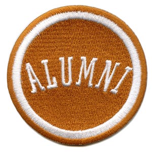 May include: A round, orange embroidered patch with a white border and the word "ALUMNI" in white lettering.