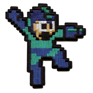 May include: A blue and green pixelated embroidered patch of a video game character. The character is in a blue helmet and has a green body. The character is in a running pose with one arm raised.
