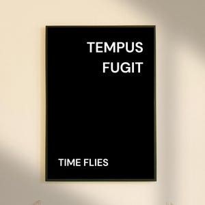 May include: Black and white framed print with the Latin phrase "Tempus Fugit" and the English translation "Time Flies".