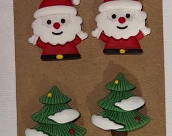 May include: Set of four Christmas-themed buttons featuring two Santa Claus figures with red hats and white beards and two green Christmas trees with white snow accents.