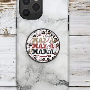 May include: A white marble phone case with a pop-up grip featuring the words "MAMA" in red and black, with a lightning bolt and baseballs. The grip has a leopard print border.