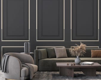 May include: A living room scene featuring a dark gray wall with three rectangular molding panels. A light gray armchair with a draped throw, a dark olive sofa with cushions, and a dark wood coffee table with a vase and books.