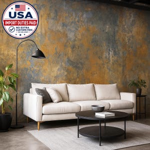 May include: A three-cushion off-white sofa with light wooden legs, a black arched floor lamp, and a round two-tier black coffee table. The sofa features two light pillows and one dark gray pillow. A potted green plant stands to the left.