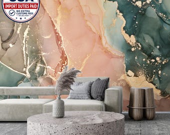 May include: A wall mural featuring an abstract alcohol ink design in shades of blush pink, deep emerald green, and gold metallic veins. The mural serves as a backdrop for a light gray sofa, a round speckled stone coffee table, and a wooden stool.