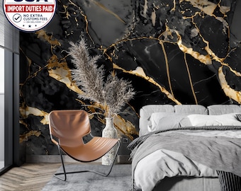 May include: A bedroom interior featuring a black and gold marble patterned wall mural. The room includes a brown leather lounge chair with a black metal frame, a tall speckled vase with dried grass, and a bed with white and gray bedding.