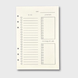 May include: A blank, cream-colored, printable planner page with a date, to do, priorities, and meetings & calls sections. Each section has a list of checkboxes and lines for writing.