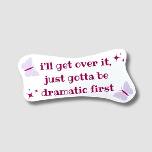 May include: White sticker with pink butterflies and glitter. The sticker says "i'll get over it, just gotta be dramatic first."