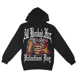 May include: Black hooded sweatshirt with a graphic print of a stack of books tied with a bow and the text "All Booked For Valentines Day".