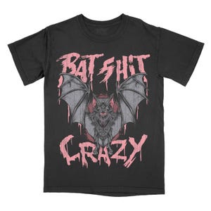 May include: Black t-shirt with a pink graphic of a bat with the text "BAT SHIT CRAZY" printed on it.