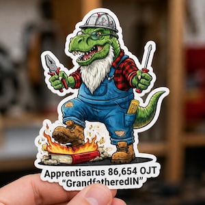 May include: A sticker featuring a green dinosaur in a hard hat and overalls, holding tools. The dinosaur has a white beard and is standing on a book engulfed in flames. Text at the bottom reads "Apprentisaurus 86,654 OJT 'GrandfatheredIN'".