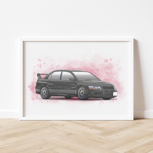 May include: Framed print of a dark gray sports car with a rear spoiler, set against a pink watercolor background. The car has silver wheels and is displayed in a white frame, suitable for wall decor.