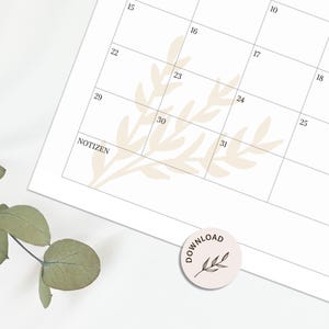 May include: A white monthly calendar page with black grid lines and numbers, featuring a faint beige botanical leaf illustration in the background. The word NOTIZEN is printed in the bottom left corner, and a small circular tag says DOWNLOAD.