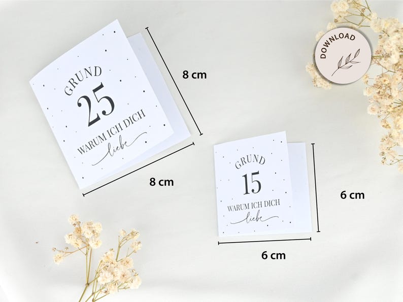 May include: Two white cards with black text and small black dots. The larger card reads "GRUND 25 WARUM ICH DICH liebe" and measures 8 inches by 8 inches. The smaller card reads "GRUND 15 WARUM ICH DICH liebe" and measures 6 inches by 6 inches.