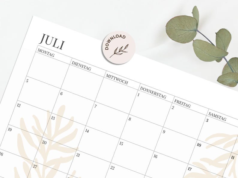 May include: A white monthly calendar page for the month of July with black text in German, featuring a grid layout with numbered days. A circular sticker with the text DOWNLOAD and a leaf illustration is placed on the top centre of the page.
