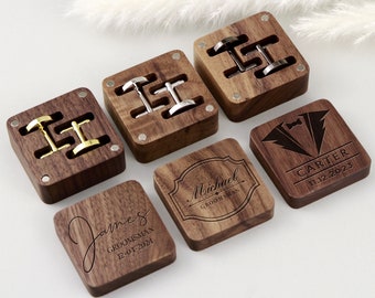 May include: Six wooden boxes with engraved text and a pair of cufflinks inside. The boxes are made of dark wood and have a square shape. The text on the boxes includes names, dates, and the word "Groomsman".