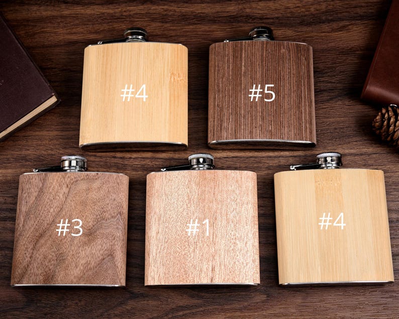 May include: Six wooden flask hip flasks with different wood grains and finishes. The flasks are labeled with numbers 1, 3, 4, and 5.