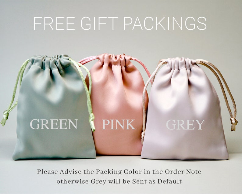 May include: Three drawstring bags in green, pink, and grey. The bags are made of a soft, fabric-like material. The text "FREE GIFT PACKINGS" is at the top of the image. The text "Please Advise the Packing Color in the Order Note otherwise Grey will be Sent as Default" is at the bottom of the image.
