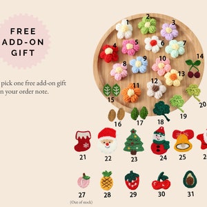 May include: A collection of colorful, crocheted appliques, including flowers, leaves, and holiday-themed designs like a Christmas tree and Santa Claus. The image also includes the text "FREE ADD-ON GIFT".