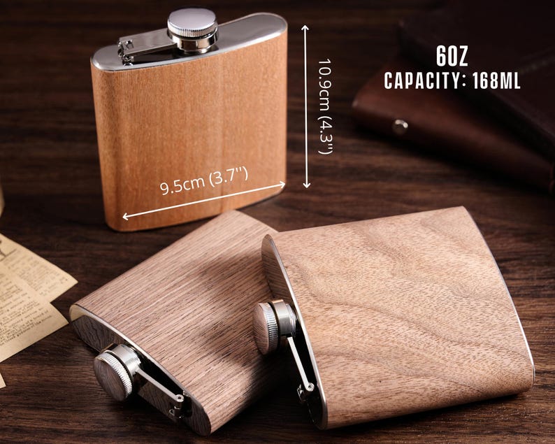 May include: Two wooden flask hip flasks with stainless steel caps and a silver finish. The flasks are 9.5 cm (3.7") wide and 10.9 cm (4.3") tall. The larger flask has the text "6oz CAPACITY: 168ML" printed on it.