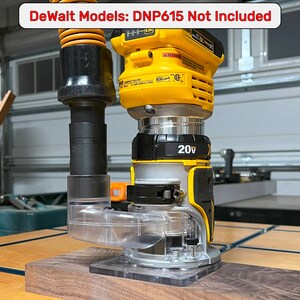 May include: A yellow and black DeWalt 20V MAX cordless router with a clear dust collection system attached. The router is sitting on a piece of wood. The text "DeWalt Models: DNP615 Not Included" is written in red at the top of the image.