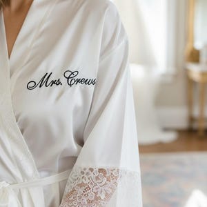 May include: A rustic wooden sign with the text "Welcome to our home" in white lettering. The sign features a distressed finish and a simple, inviting design, perfect for front door decor.