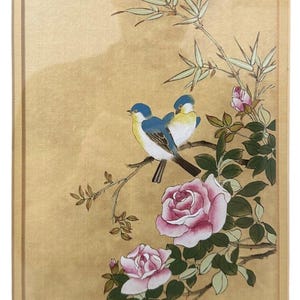 May include: A framed painting depicting two blue and yellow birds perched on a branch with pink roses and green leaves. The artist's signature, "Peter Chan", is in the bottom right corner.