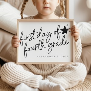 May include: A child holds a white sign with black text that reads "first day of fourth grade" and "SEPTEMBER 5, 2025". A black star with a white outline is drawn next to the text.